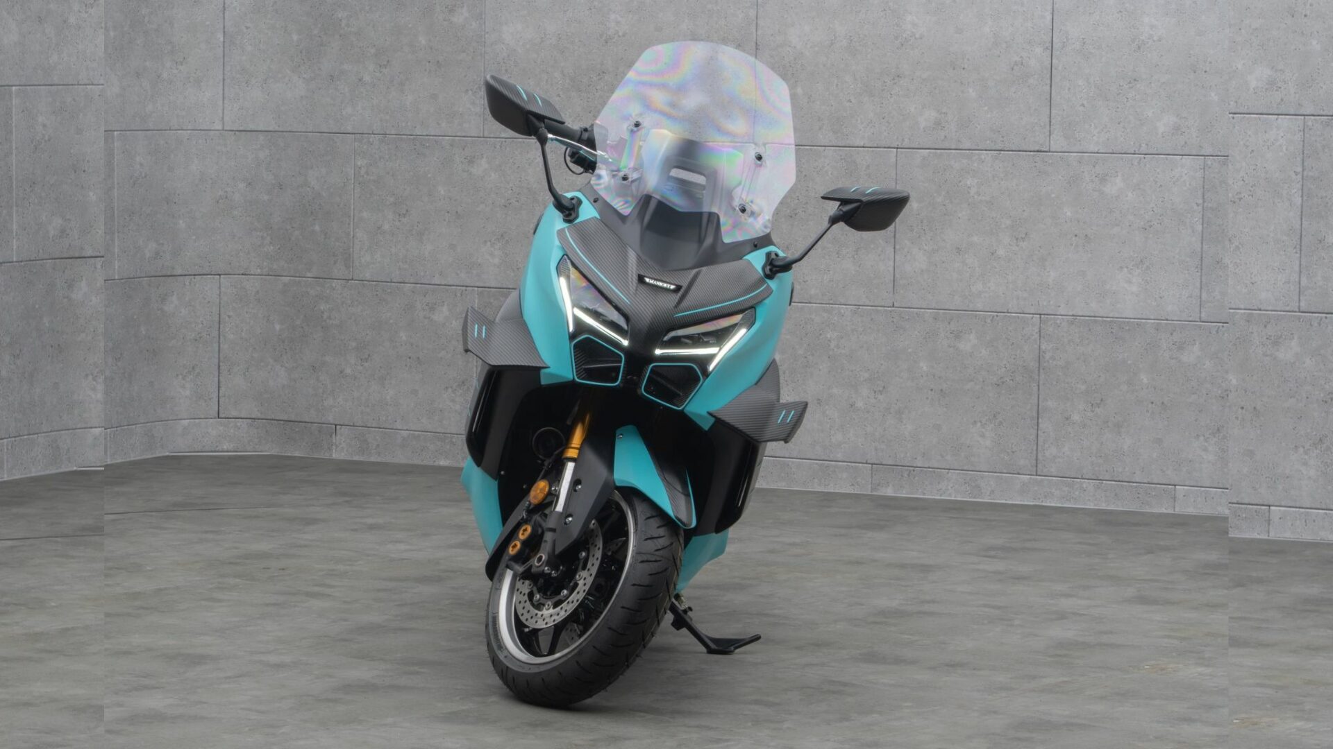 Vue plein avant du Mansory T-Max sur base de Yamaha TMAX 560 avec carénage carbone, winglets aérodynamiques et teinte bleu clair