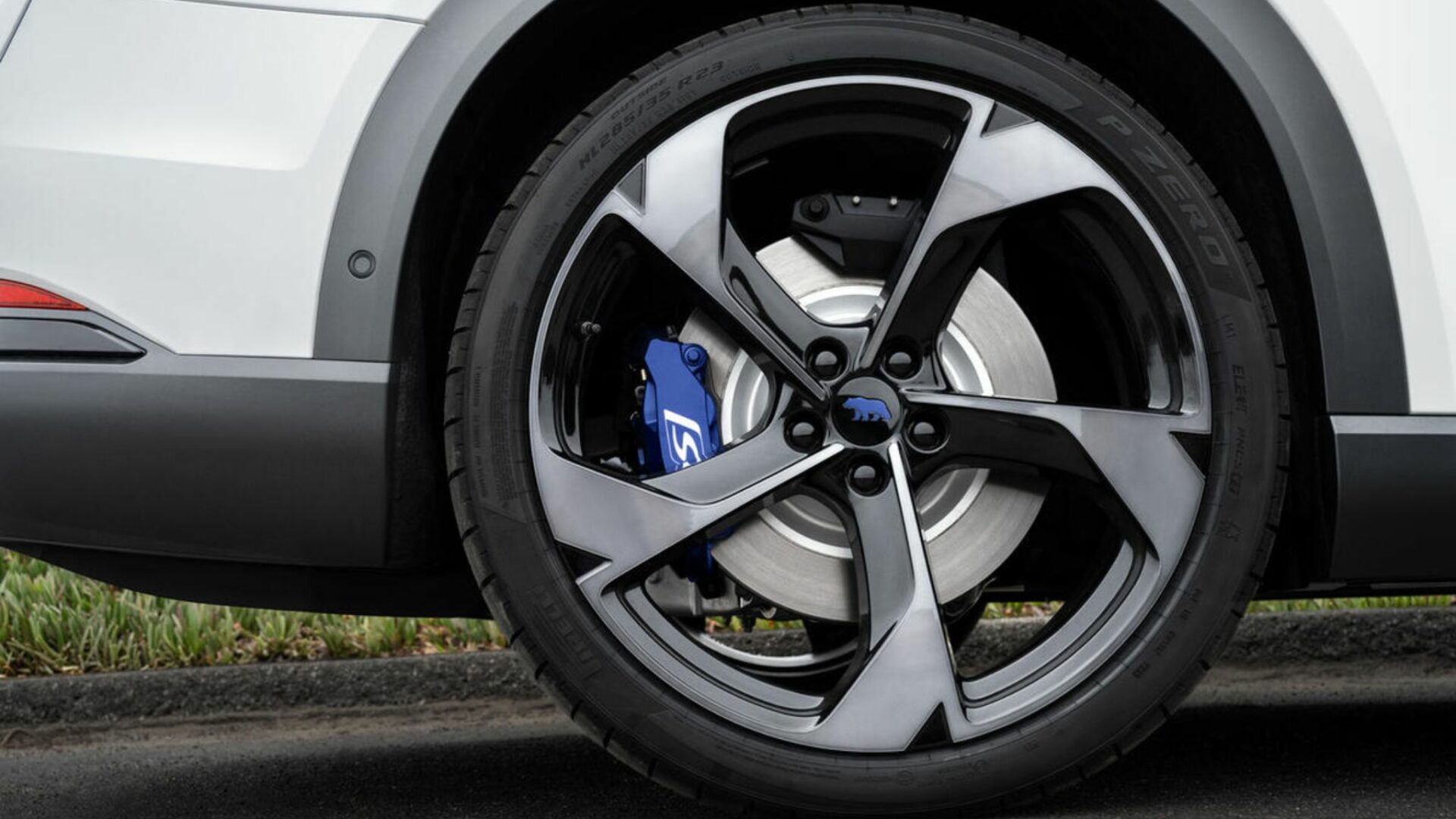 Vue de profil de la roue arrière de 23 pouces du Lucid Gravity GT-S montrant la jante biton, le pneu Pirelli P Zero et l'étrier de frein bleu S