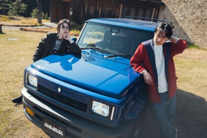 Suzuki Jimny R5 bleu de DAMD avec kit carrosserie façon Renault 5 et deux personnes posant sur le capot