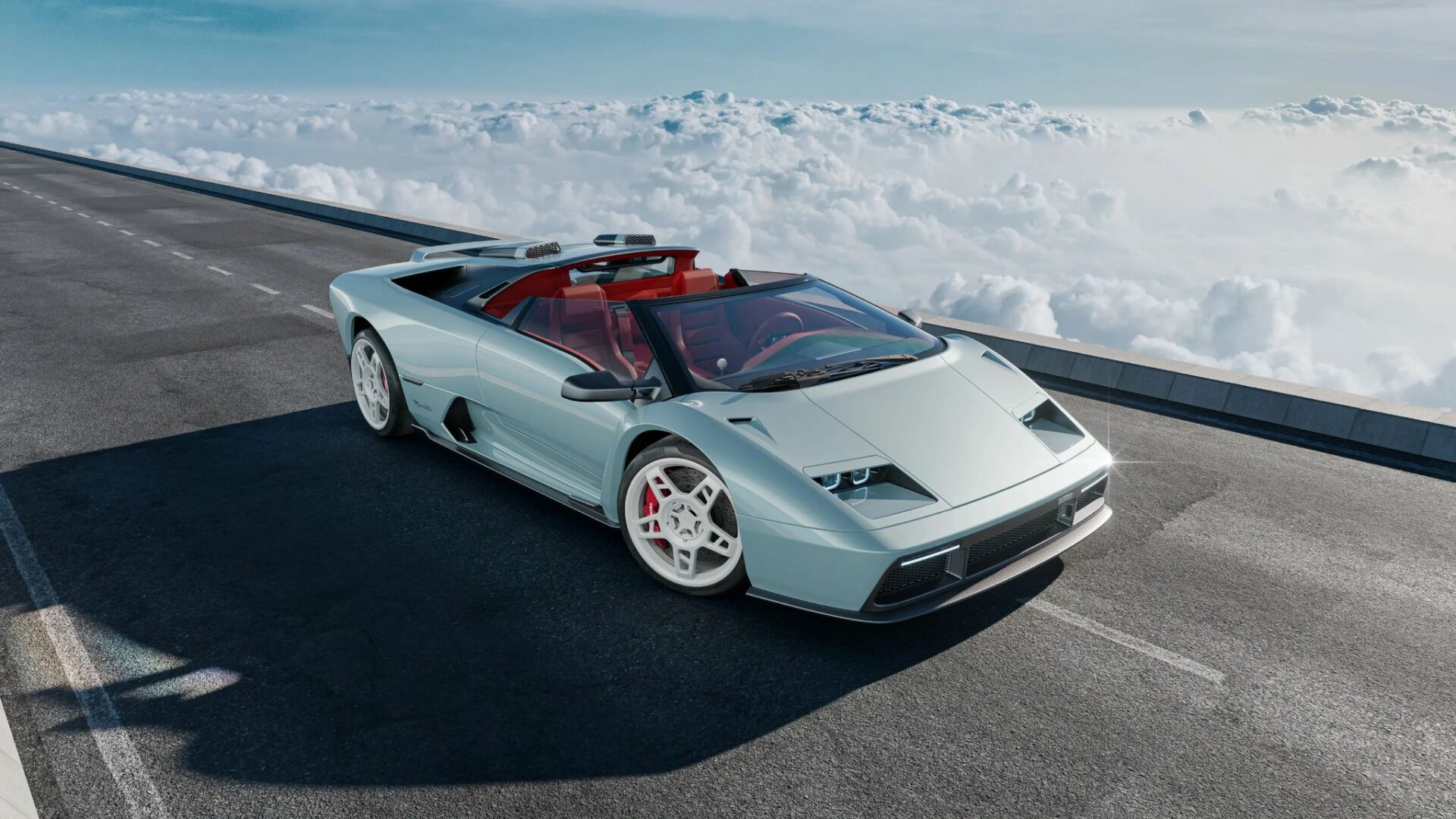 Vue de trois-quarts avant en plongée de l'Eccentrica V12 Roadster, restomod basé sur la Lamborghini Diablo roadster, sur piste au-dessus des nuages