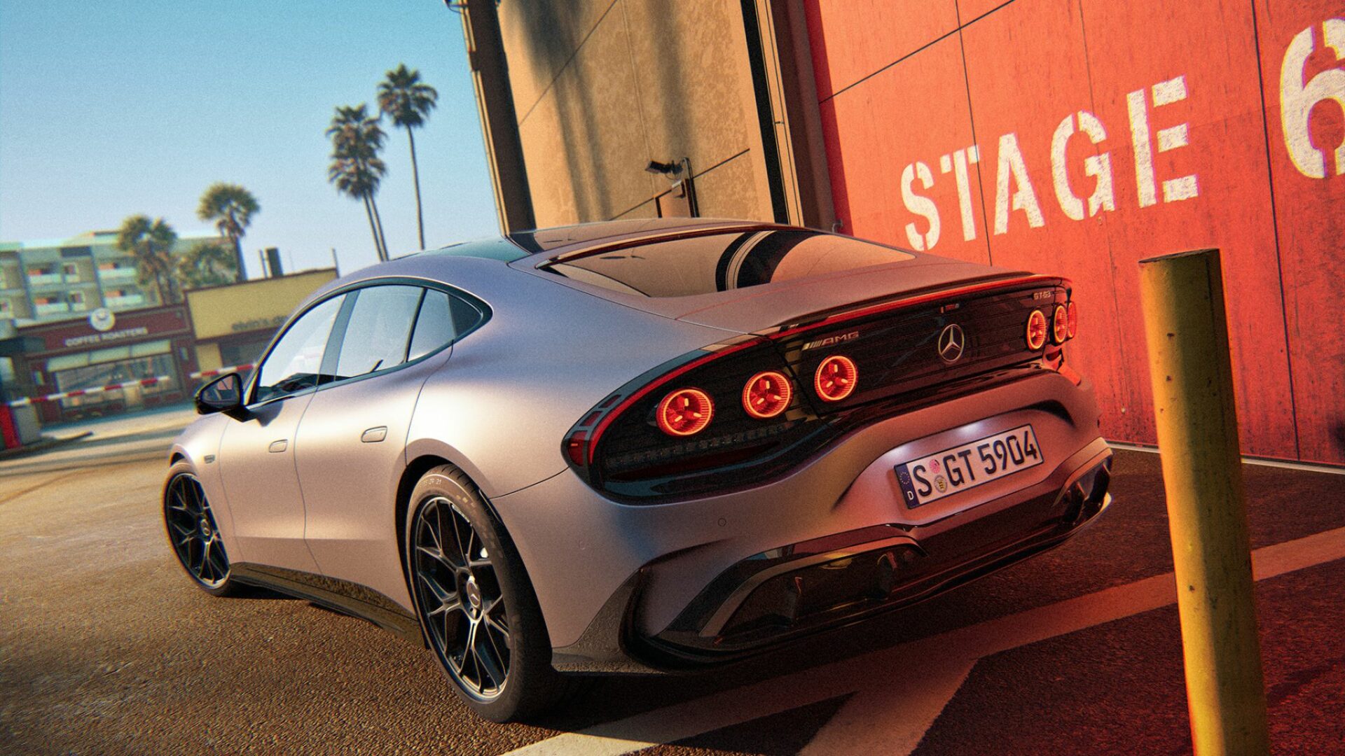 Vue trois-quarts arrière de la Mercedes-AMG GT 4 portes électrique GT 53 gris mat stationnée devant un bâtiment studio de cinéma